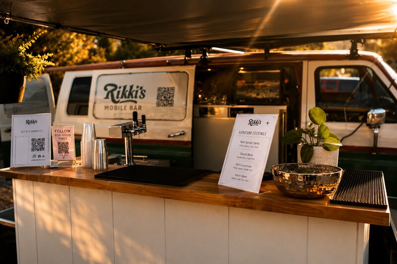 Rikki's Mobile Bar setup with menus and a cocktail