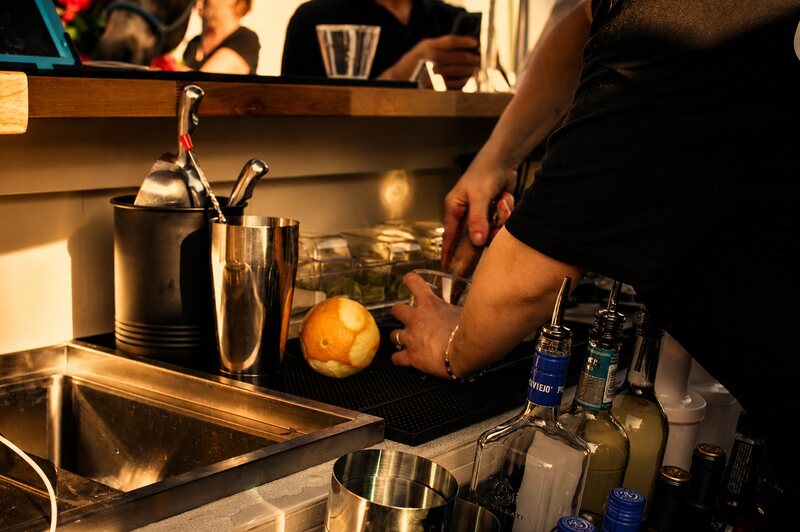 Bartender preparing drinks behind Rikki's mobile bar