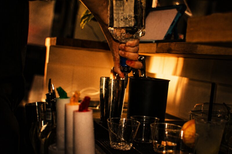 Close-up of a cocktail being poured behind the bar
