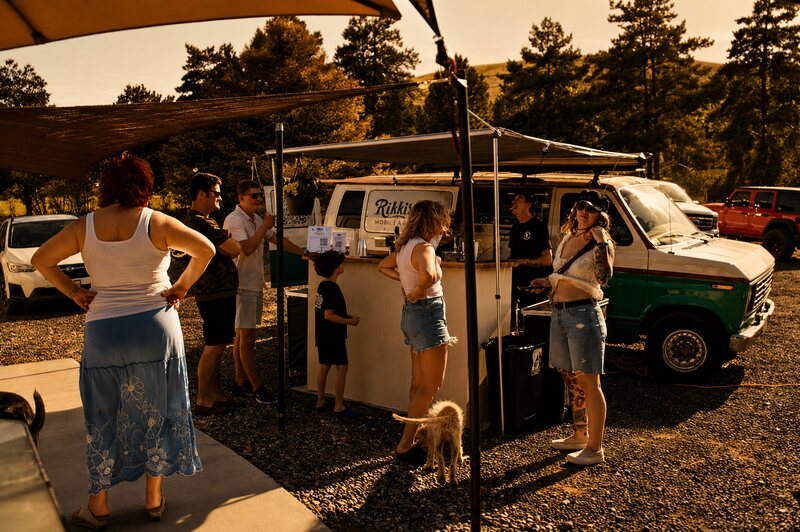 Guests gathering near Rikki's vintage mobile bar van