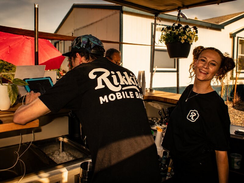 Rikki's Mobile Bar team serving behind the bar